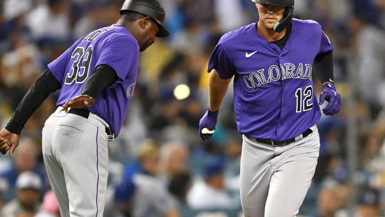 Oct 4, 2022; Los Angeles, California, USA; Colorado Rockies left fielder Sean Bouchard (12) is congratulated by third base coach Stu Cole (39) after a solo home run in the third inning against the Los Angeles Dodgers at Dodger Stadium. Mandatory Credit: Jayne Kamin-Oncea-USA TODAY Sports