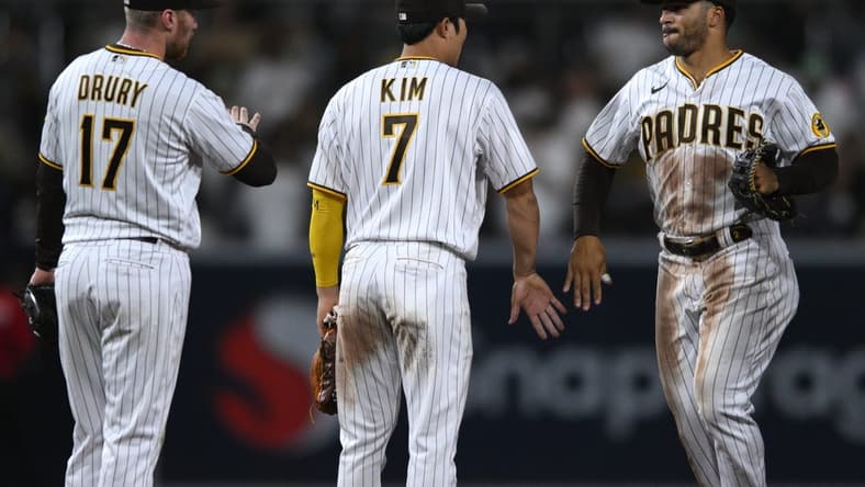 Oct 4, 2022; San Diego, California, USA; San Diego Padres center fielder Trent Grisham (right) celebrates with shortstop Ha-Seong Kim (7) and second baseman Brandon Drury (17) after defeating the San Francisco Giants at Petco Park. Mandatory Credit: Orlando Ramirez-USA TODAY Sports