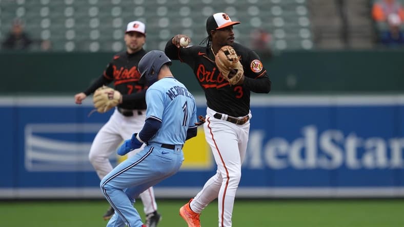 Oct 5, 2022; Baltimore, MD, USA; Baltimore Orioles shortstop Jorge Mateo (3) forces out Toronto Blue Jays second baseman Whit Merrifield (1) to start a second inning double play at Oriole Park at Camden Yards. Mandatory Credit: Mitch Stringer-USA TODAY Sports