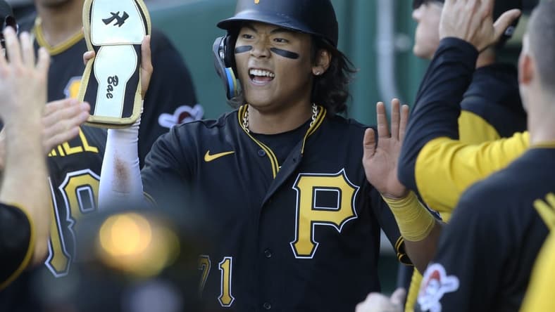 Oct 5, 2022; Pittsburgh, Pennsylvania, USA; Pittsburgh Pirates center fielder Ji Hwan Bae (71) high-fives in the dugout after scoring a run against the St. Louis Cardinals during the third inning at PNC Park. Mandatory Credit: Charles LeClaire-USA TODAY Sports