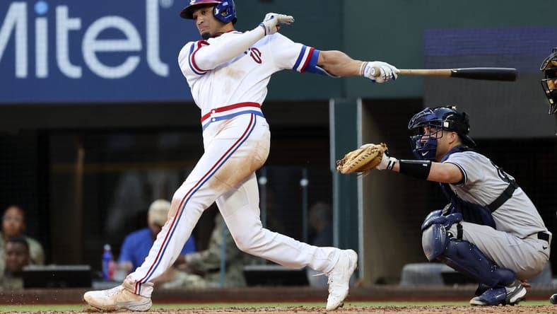 Oct 5, 2022; Arlington, Texas, USA; Texas Rangers right fielder Bubba Thompson (65) hits an rbi double during the fifth inning against the New York Yankees at Globe Life Field. Mandatory Credit: Kevin Jairaj-USA TODAY Sports