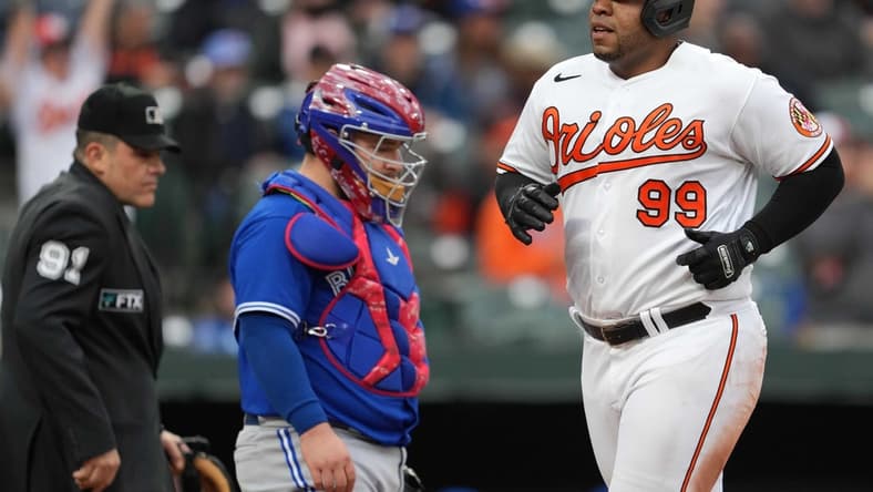 Oct 5, 2022; Baltimore, Maryland, USA; Baltimore Orioles first baseman Jesus Aguilar (99) scores to tie the game in the sixth inning against the Toronto Blue Jays at Oriole Park at Camden Yards. Mandatory Credit: Mitch Stringer-USA TODAY Sports
