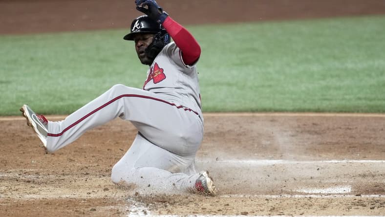 Oct 5, 2022; Miami, Florida, USA; Atlanta Braves center fielder Guillermo Heredia (38) scores in the third inning against the Miami Marlins at loanDepot Park. Mandatory Credit: Jim Rassol-USA TODAY Sports