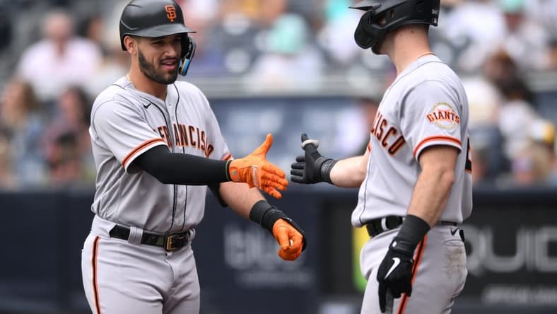 Oct 5, 2022; San Diego, California, USA; San Francisco Giants designated hitter David Villar (left) is congratulated by designated hitter Joey Bart (21) after hitting a home run against the San Diego Padres during the eighth inning at Petco Park. Mandatory Credit: Orlando Ramirez-USA TODAY Sports