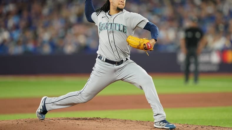 Oct 7, 2022; Toronto, Ontario, CAN; Seattle Mariners starting pitcher Luis Castillo (21) pitches in the first inning against the Toronto Blue Jays during game one of the Wild Card series for the 2022 MLB Playoffs at Rogers Centre. Mandatory Credit: Nick Turchiaro-USA TODAY Sports