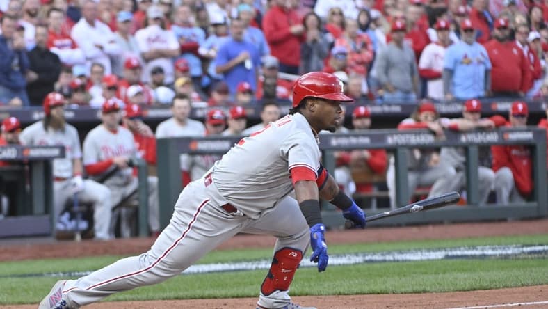 Oct 7, 2022; St. Louis, Missouri, USA; Philadelphia Phillies second baseman Jean Segura (2) hits a single during the ninth inning that scored the go ahead run against the St. Louis Cardinals during game one of the Wild Card series for the 2022 MLB Playoffs at Busch Stadium. Mandatory Credit: Jeff Curry-USA TODAY Sports