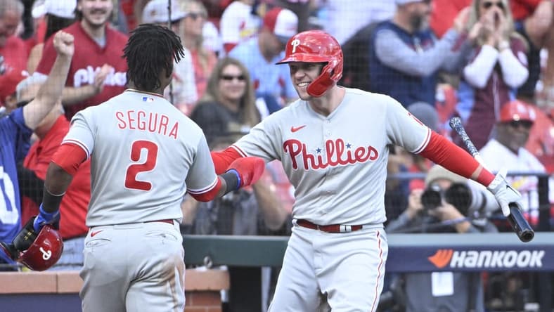 Oct 7, 2022; St. Louis, Missouri, USA; Philadelphia Phillies first baseman Rhys Hoskins (17) congratulates second baseman Jean Segura (2) during the ninth inning against the St. Louis Cardinals during game one of the Wild Card series for the 2022 MLB Playoffs at Busch Stadium. Mandatory Credit: Jeff Curry-USA TODAY Sports