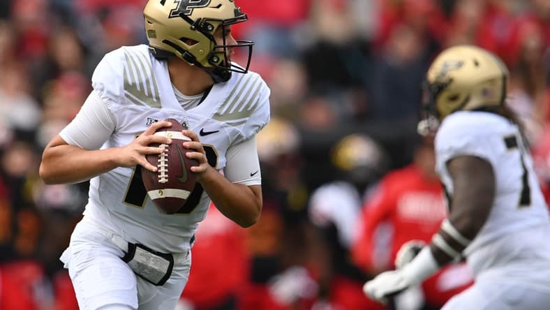 Oct 8, 2022; College Park, Maryland, USA;  Purdue Boilermakers quarterback Aidan O'Connell (16) rolls out to pass during the first half against the Purdue Boilermakers at SECU Stadium. Mandatory Credit: Tommy Gilligan-USA TODAY Sports