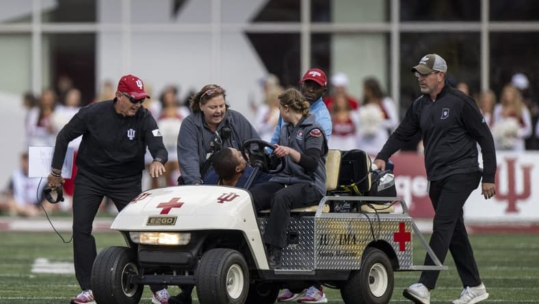 Oct 8, 2022; Bloomington, Indiana, USA;  Indiana Hoosiers head coach Tom Allen wishes Michigan Wolverines RB coach Mike Hart well as he is pulled off the field on a stretcher with an injury during the first quarter at Memorial Stadium. Mandatory Credit: Marc Lebryk-USA TODAY Sports