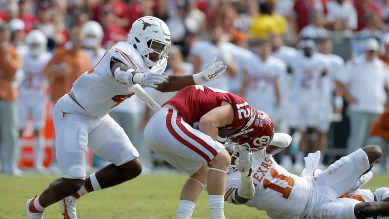 Oklahoma Sooners wide receiver Drake Stoops (12) is brought down by Texas Longhorns defensive back Austin Jordan (4) and Texas Longhorns defensive back Anthony Cook (11) during the Red River Showdown college football game between the University of Oklahoma (OU) and Texas at the Cotton Bowl in Dallas, Saturday, Oct. 8, 2022.

Lx16259