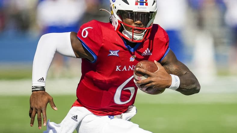 Oct 8, 2022; Lawrence, Kansas, USA; Kansas Jayhawks quarterback Jalon Daniels (6) runs with the ball during the first half against the TCU Horned Frogs at David Booth Kansas Memorial Stadium. Mandatory Credit: Jay Biggerstaff-USA TODAY Sports
