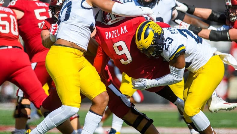Indiana's Connor Bazelak (9) is sacked by Michigan's Michael Barrett (23) during the Indiana versus Michigan football game at Memorial Stadium on Saturday, Oct. 8, 2022.

Iu Mu Fb 1h Bazelak Sack