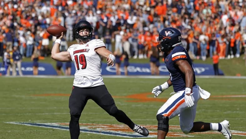 Oct 8, 2022; Charlottesville, Virginia, USA; Louisville Cardinals quarterback Brock Domann (19) passes the ball as Virginia Cavaliers linebacker Nick Jackson (6) chases during the second quarter at Scott Stadium. Mandatory Credit: Geoff Burke-USA TODAY Sports
