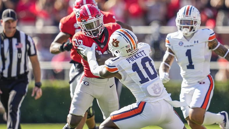 Oct 8, 2022; Athens, Georgia, USA; Georgia Bulldogs running back Daijun Edwards (30) runs against Auburn Tigers safety Zion Puckett (10) during the first quarter at Sanford Stadium. Mandatory Credit: Dale Zanine-USA TODAY Sports