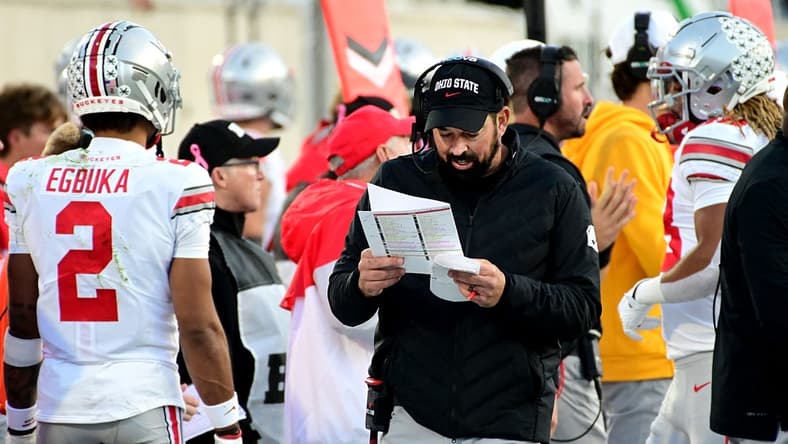 Oct 8, 2022; East Lansing, Michigan, USA; Ohio State Buckeyes head coach Ryan Day calls plays on the sidelines against the Michigan State Spartans in the fourth quarter at Spartan Stadium. Mandatory Credit: Dale Young-USA TODAY Sports