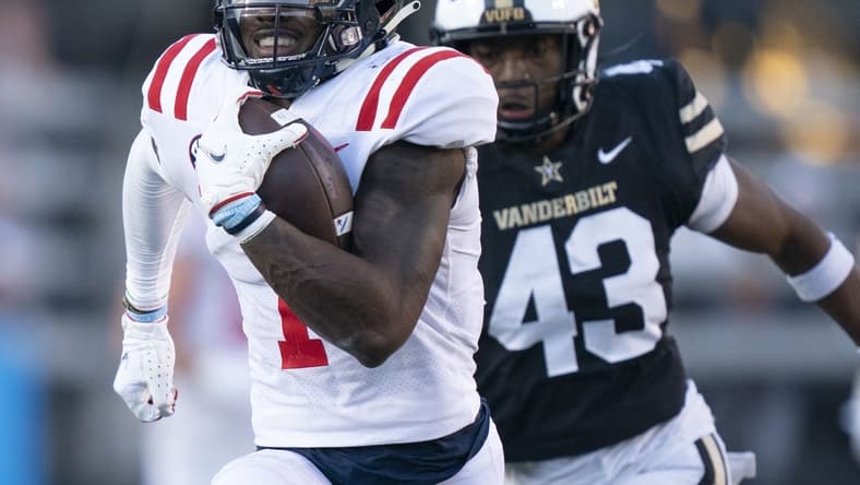 Oct 8, 2022; Nashville, Tennessee, USA; Mississippi Rebels wide receiver Jonathan Mingo (1) runs up the field with a 71 yard touchdown pass against Vanderbilt Commodores linebacker De'Rickey Wright (43) during the third quarter at FirstBank Stadium. Mandatory Credit: George Walker IV - USA TODAY Sports