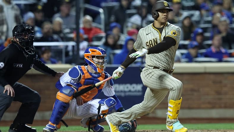 Oct 8, 2022; New York City, New York, USA; San Diego Padres right fielder Juan Soto (22) gets a hit in the fifth inning during game two of the Wild Card series against the New York Mets for the 2022 MLB Playoffs at Citi Field. Mandatory Credit: Brad Penner-USA TODAY Sports