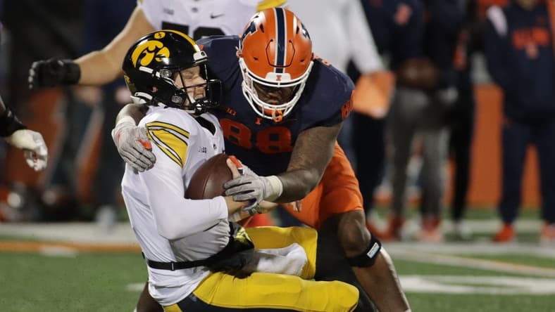 Oct 8, 2022; Champaign, Illinois, USA;  Illinois Fighting Illini defensive lineman Keith Randolph Jr. (88) sacks Iowa Hawkeyes quarterback Spencer Petras (7) during the first half at Memorial Stadium. Mandatory Credit: Ron Johnson-USA TODAY Sports