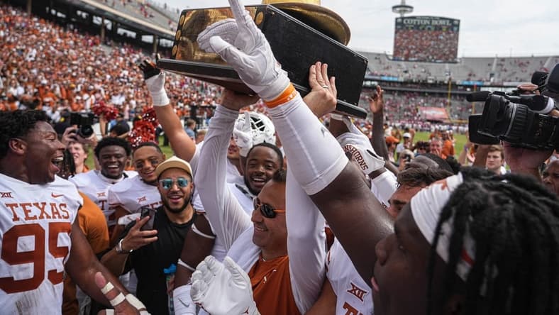 Oct 8, 2022; Dallas, Texas, USA: Texas Longhorns Longhorns head coach Steve Sarkisian holds up the Golden Hat trophy after a 49-0 victory over the Oklahoma Sooners in the annual Red River Showdown at the Cotton Bowl. Mandatory Credit: Aaron E. Martinez/Austin American-Statesman- USA TODAY NETWORK