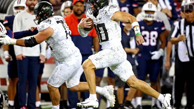 Oct 8, 2022; Tucson, Arizona, USA; Oregon Ducks quarterback Bo Nix (10) runs the ball during the second half against the Arizona Wildcats at Arizona Stadium. Mandatory Credit: Mark J. Rebilas-USA TODAY Sports
