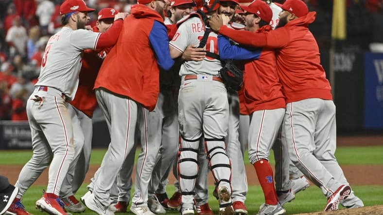 Oct 8, 2022; St. Louis, Missouri, USA; Members of the Philadelphia Phillies celebrate following their 2-0 victory against the St. Louis Cardinals in game two of the Wild Card series for the 2022 MLB Playoffs at Busch Stadium. Mandatory Credit: Jeff Curry-USA TODAY Sports