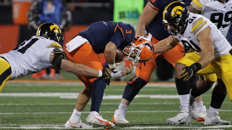 Oct 8, 2022; Champaign, Illinois, USA;  Iowa Hawkeyes defensive lineman Luke Gaffney (51) and defensive lineman Lukas Van Ness (91) tackle Illinois Fighting Illini quarterback Tommy DeVito (3) during the first half at Memorial Stadium. DeVito was injured on the play. Mandatory Credit: Ron Johnson-USA TODAY Sports