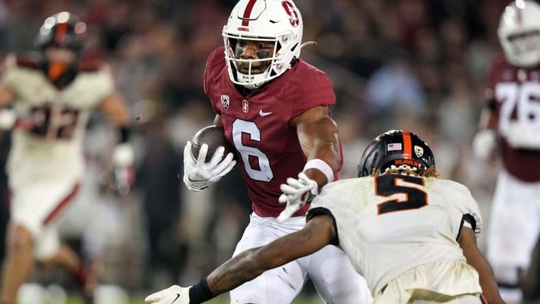 Oct 8, 2022; Stanford, California, USA; Stanford Cardinal wide receiver Elijah Higgins (6) runs after a catch against Oregon State Beavers defensive back Alex Austin (5) during the second quarter at Stanford Stadium. Mandatory Credit: Darren Yamashita-USA TODAY Sports