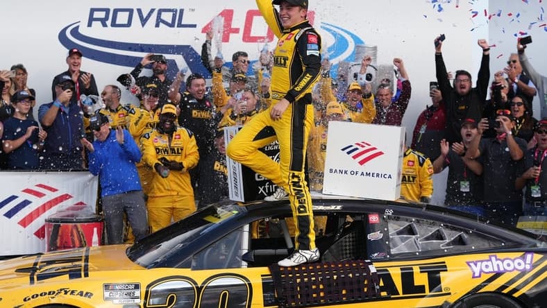 Oct 9, 2022; Concord, North Carolina, USA; NASCAR Cup Series driver Christopher Bell (20) celebrates after winning the Bank of America ROVAL 400 at Charlotte Motor Speedway Road Course. Mandatory Credit: Jasen Vinlove-USA TODAY Sports