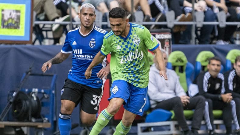 Oct 9, 2022; Seattle, Washington, USA; Seattle Sounders FC midfielder Cristian Roldan (7) dribbles the ball against San Jose Earthquakes defender Miguel Trauco (31) during the first half at Lumen Field. Mandatory Credit: Stephen Brashear-USA TODAY Sports