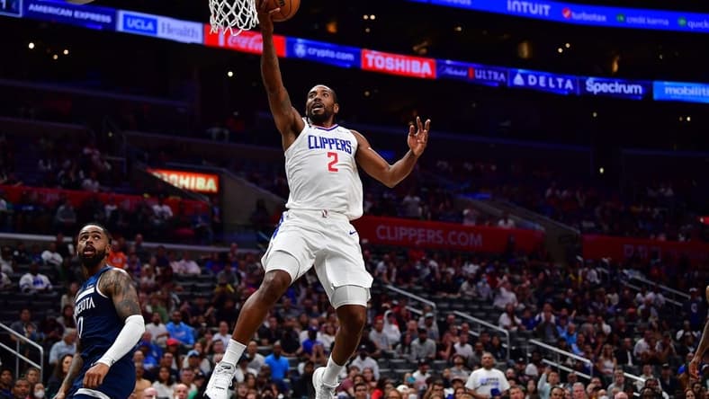 Oct 9, 2022; Los Angeles, California, USA; Los Angeles Clippers forward Kawhi Leonard (2) moves to the basket ahead of Minnesota Timberwolves guard D'Angelo Russell (0) during the first half at Crypto.com Arena. Mandatory Credit: Gary A. Vasquez-USA TODAY Sports