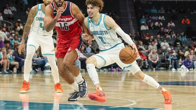Oct 10, 2022; Charlotte, North Carolina, USA;  Charlotte Hornets guard LaMelo Ball (1) drives the lane against Washington Wizards forward Anthony Gill (16) during the second half at Spectrum Center. Mandatory Credit: Jim Dedmon-USA TODAY Sports