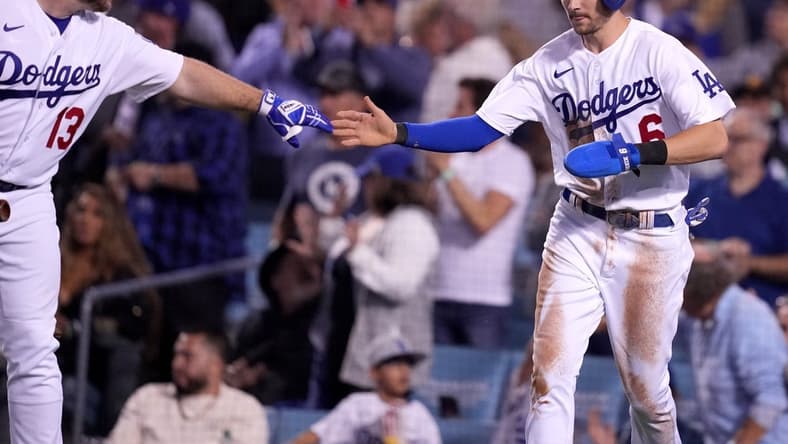 Oct 11, 2022; Los Angeles, California, USA; Los Angeles Dodgers shortstop Trea Turner (6) celebrates with third baseman Max Muncy (13) after scoring in the third inning of game one of the NLDS for the 2022 MLB Playoffs against the San Diego Padres at Dodger Stadium. Mandatory Credit: Kirby Lee-USA TODAY Sports