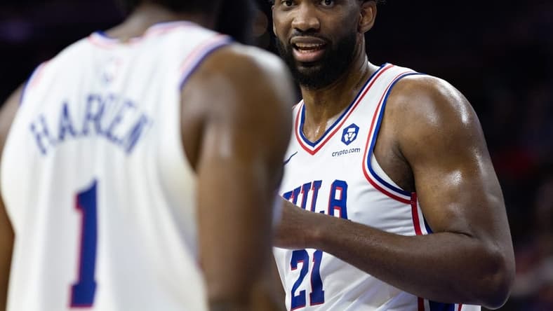 Oct 12, 2022; Philadelphia, Pennsylvania, USA; Philadelphia 76ers center Joel Embiid (21) talks with guard James Harden (1) during the first quarter against the Charlotte Hornets at Wells Fargo Center. Mandatory Credit: Bill Streicher-USA TODAY Sports