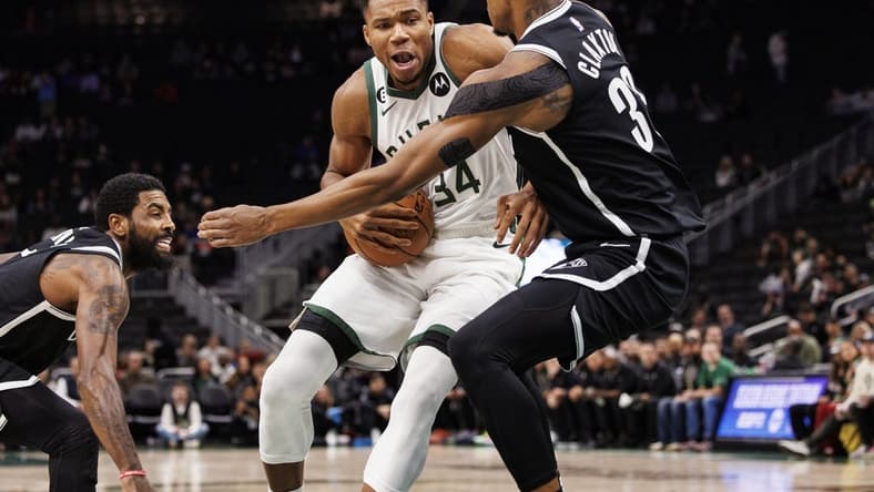 Oct 12, 2022; Milwaukee, Wisconsin, USA; Milwaukee Bucks forward Giannis Antetokounmpo (34) drives for the basket against Brooklyn Nets forward Nic Claxton (33) during the first quarter at Fiserv Forum. Mandatory Credit: Jeff Hanisch-USA TODAY Sports