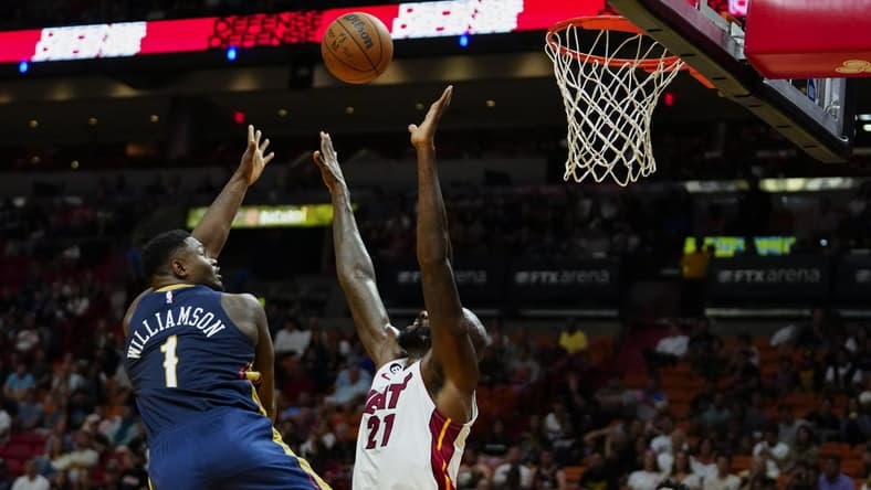 Oct 12, 2022; Miami, Florida, USA; New Orleans Pelicans forward Zion Williamson (1) lays the ball up against Miami Heat center Dewayne Dedmon (21) during the first quarter at FTX Arena. Mandatory Credit: Rich Storry-USA TODAY Sports