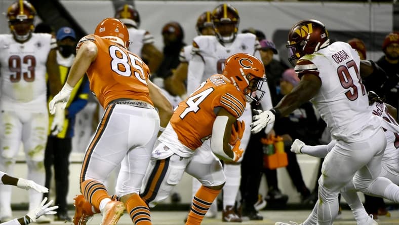 Oct 13, 2022; Chicago, Illinois, USA; Chicago Bears running back Khalil Herbert (24) runs past Washington Commanders defensive end Efe Obada (97) during the first half at Soldier Field. Mandatory Credit: Matt Marton-USA TODAY Sports