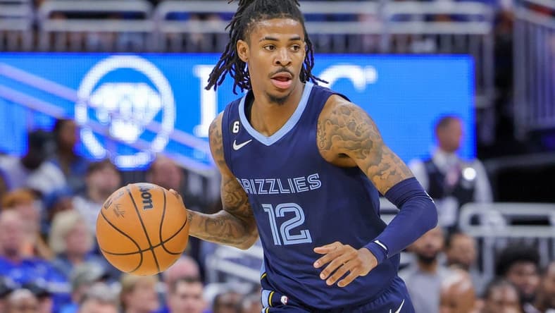 Oct 11, 2022; Orlando, Florida, USA; Memphis Grizzlies guard Ja Morant (12) brings the ball up court during the second half against the Memphis Grizzlies at Amway Center. Mandatory Credit: Mike Watters-USA TODAY Sports