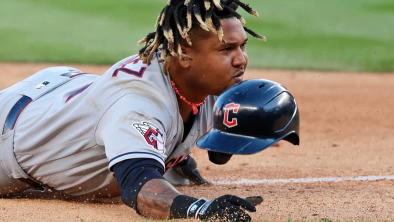 Oct 14, 2022; Bronx, New York, USA; Cleveland Guardians third baseman Jose Ramirez (11) reacts after he loses his helmet sliding safely into third base after advancing following a throwing error committed by New York Yankees third baseman Josh Donaldson (not pictured) during the tenth inning in game two of the ALDS for the 2022 MLB Playoffs at Yankee Stadium. Mandatory Credit: Vincent Carchietta-USA TODAY Sports