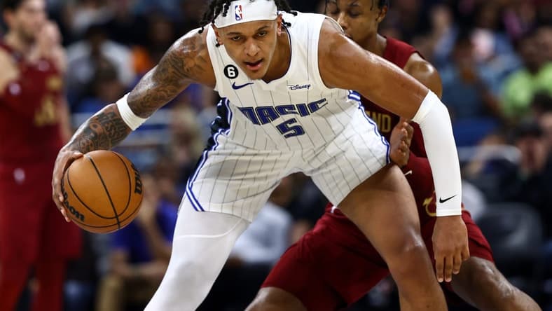 Oct 14, 2022; Orlando, Florida, USA; Orlando Magic forward Paolo Banchero (5) is defended by Cleveland Cavaliers forward Isaac Okoro (35) during the second quarter at Amway Center. Mandatory Credit: Kim Klement-USA TODAY Sports