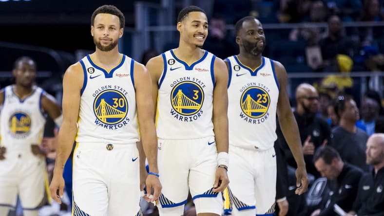 Oct 14, 2022; San Francisco, California, USA; Golden State Warriors guard Jordan Poole (3) and guard Stephen Curry (30) and forward Draymond Green (23) re-enter the court after a time-out during the first half of the game against the Denver Nuggets at Chase Center. Mandatory Credit: John Hefti-USA TODAY Sports