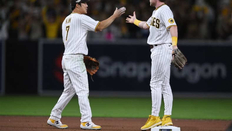 Oct 14, 2022; San Diego, California, USA; San Diego Padres shortstop Ha-Seong Kim (7) and second baseman Jake Cronenworth (9) celebrate defeating the Los Angeles Dodgers during game three of the NLDS for the 2022 MLB Playoffs at Petco Park. Mandatory Credit: Orlando Ramirez-USA TODAY Sports