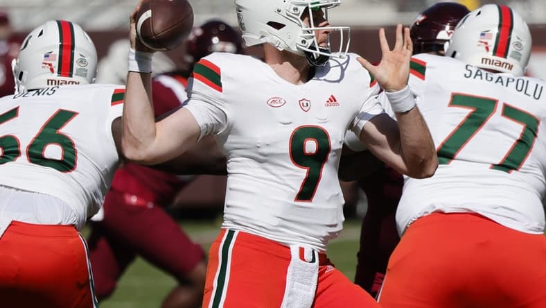 Oct 15, 2022; Blacksburg, Virginia, USA;  Miami Hurricanes quarterback Tyler Van Dyke (9) throws a pass as offensive linemen Logan Sagapolu (77) and Jonathan Denis (56) block during the first quarter against the Virginia Tech Hokies at Lane Stadium. Mandatory Credit: Reinhold Matay-USA TODAY Sports