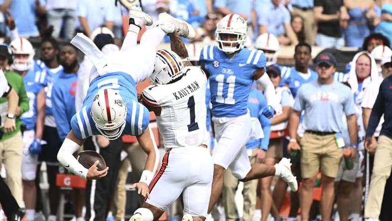 Oct 15, 2022; Oxford, Mississippi, USA; Mississippi Rebels quarterback Jaxson Dart (2) is tackled by Auburn Tigers safety Donovan Kaufman (1) during the first quarter at Vaught-Hemingway Stadium. Mandatory Credit: Matt Bush-USA TODAY Sports