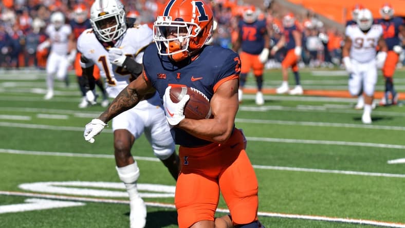 Oct 15, 2022; Champaign, Illinois, USA;  Illinois Fighting Illini running back Chase Brown (2) scores a touchdown during the first half against the Minnesota Golden Gophers at Memorial Stadium. Mandatory Credit: Ron Johnson-USA TODAY Sports