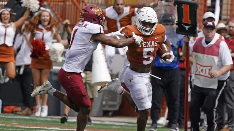 Oct 15, 2022; Austin, Texas, USA; Texas Longhorns running back Bijan Robinson (5) runs for yardage against Iowa State Cyclones defensive back Anthony Johnson, Jr.  (1) during the first half at Darrell K Royal-Texas Memorial Stadium. Mandatory Credit: Scott Wachter-USA TODAY Sports