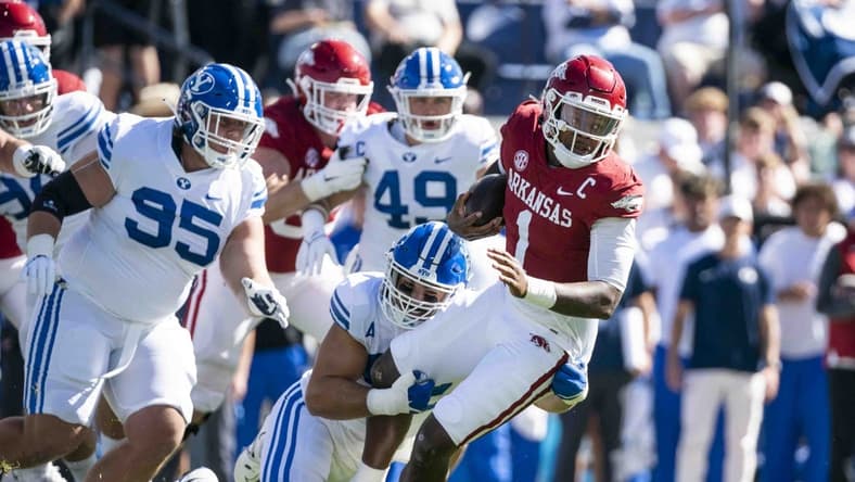 Oct 15, 2022; Provo, Utah, USA; Arkansas Razorbacks quarterback Jakob Robinson (1) is brought down Brigham Young University Cougars defensive lineman Tyler Batty (92) in the first quarter at LaVell Edwards Stadium. Mandatory Credit: Gabriel Mayberry-USA TODAY Sports