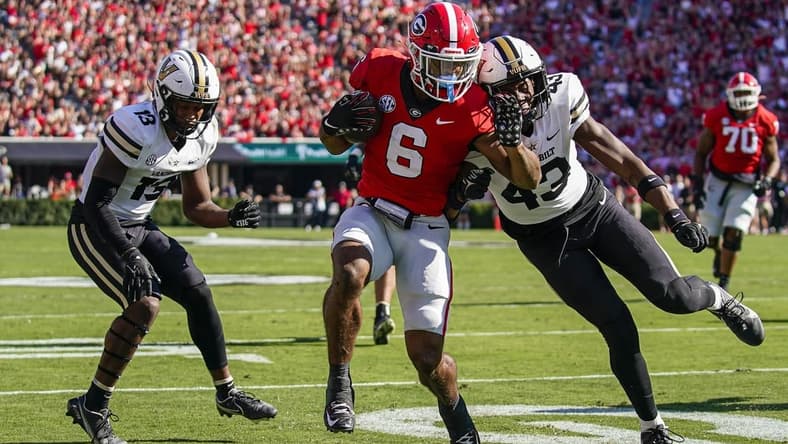 Oct 15, 2022; Athens, Georgia, USA; Georgia Bulldogs running back Kenny McIntosh (6) scores a touchdown past Vanderbilt Commodores linebacker De'Rickey Wright (43) after catching a pass during the first quarter at Sanford Stadium. Mandatory Credit: Dale Zanine-USA TODAY Sports