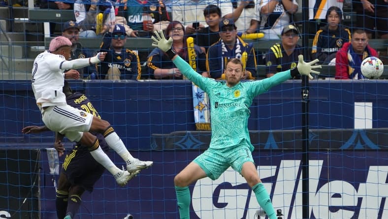 Oct 15, 2022; Carson, California, US; Los Angeles Galaxy defender Julian Araujo (2) scores a goal during the second half against Nashville SC goalkeeper Joe Willis (1) at Dignity Health Sports Park. Mandatory Credit: Kirby Lee-USA TODAY Sports
