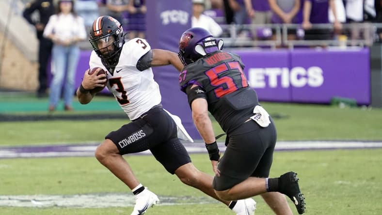 Oct 15, 2022; Fort Worth, Texas, USA; Oklahoma State Cowboys quarterback Spencer Sanders (3) tries to the turn the corner on TCU Horned Frogs linebacker Johnny Hodges (57) during the second half at Amon G. Carter Stadium. Mandatory Credit: Raymond Carlin III-USA TODAY Sports