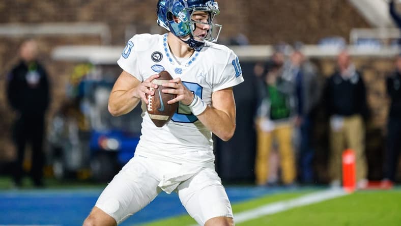 Oct 15, 2022; Durham, North Carolina, USA;  North Carolina Tar Heels quarterback Drake Maye (10) with the football during the first half at Wallace Wade Stadium. Mandatory Credit: Jaylynn Nash-USA TODAY Sports